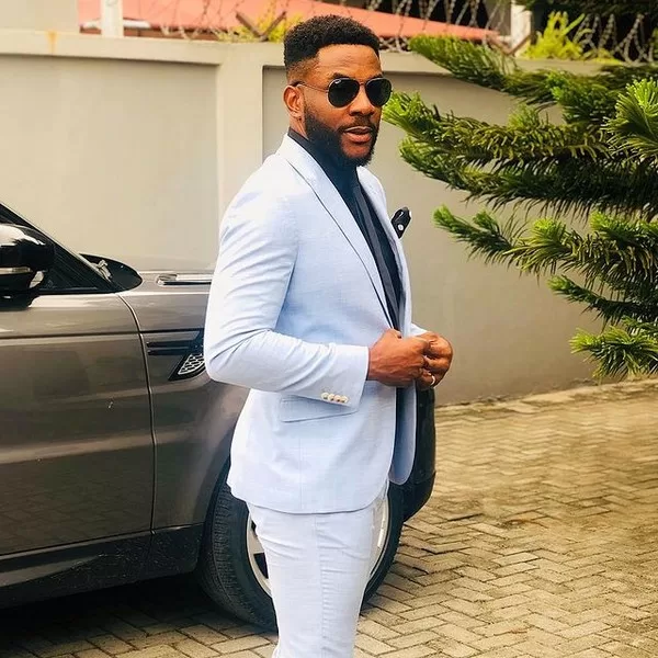 Ebuka Obi-Uchendu posing with his Range Rover Sport SUV
